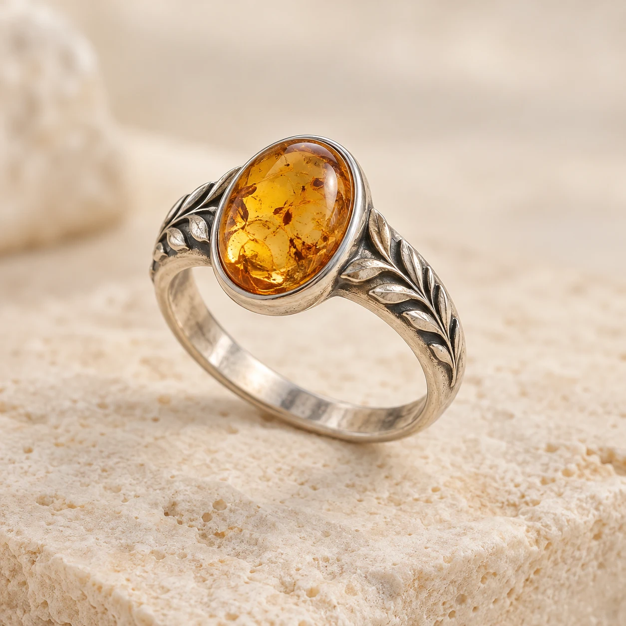 Laurel Light: light-honey oval amber ring with laurel leaves